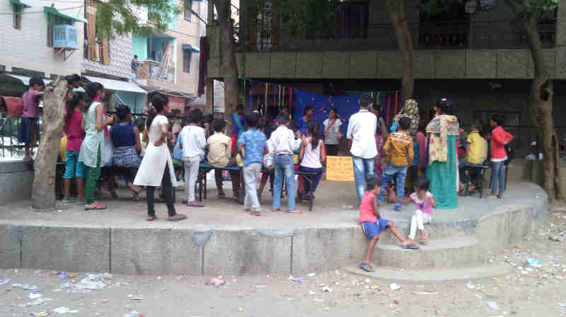 People watching street play – चमेली की पढ़ाई – which highlights the problems in the current education ecosystem.