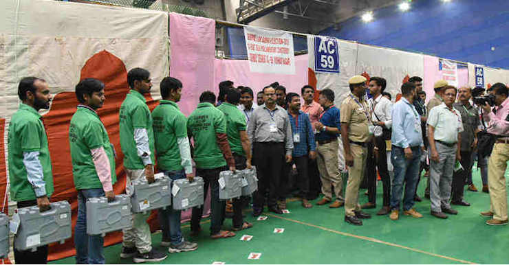 The electoral officials carrying Electronic Voting Machines (EVMs) for counting, at a counting centre of General Election 2019, at CWG Village, Sports Complex, in New Delhi on May 23, 2019. Photo: PIB