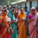 Smokescreen Report. AI-generated representational image of men and women standing outside a polling booth to vote in an Indian election. Photo: RMN News Service